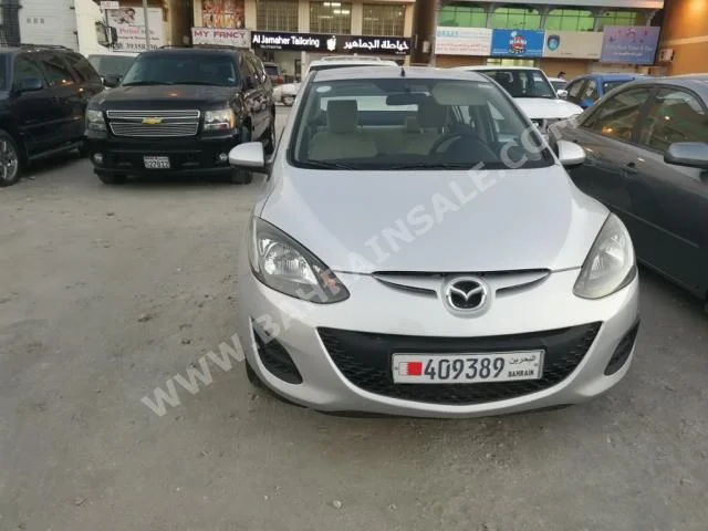 Mazda  Mazda 2  2012  Sedan  Automatic  4  90,000  FWD  Silver  Gasoline